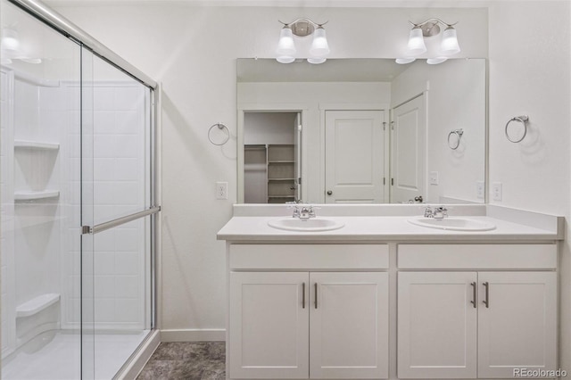 bathroom featuring vanity and a shower with door