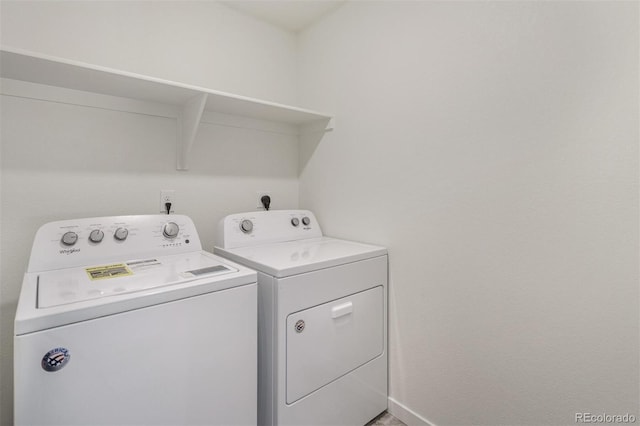 clothes washing area with washer and dryer