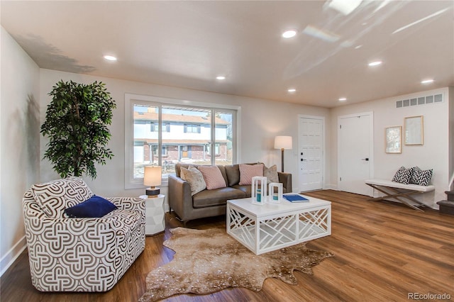 living area with stairs, wood finished floors, visible vents, and recessed lighting