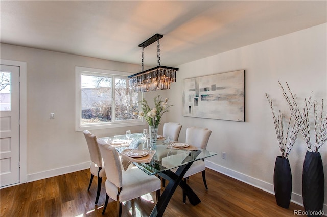 dining room featuring plenty of natural light, baseboards, and wood finished floors