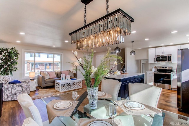 dining area with wood finished floors and recessed lighting