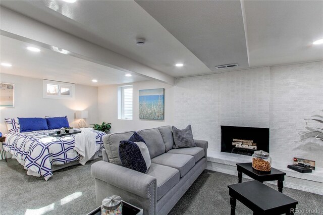 living area featuring carpet, beam ceiling, recessed lighting, visible vents, and a fireplace with raised hearth