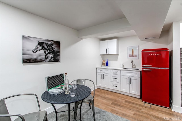 dining space featuring light wood-style flooring and baseboards