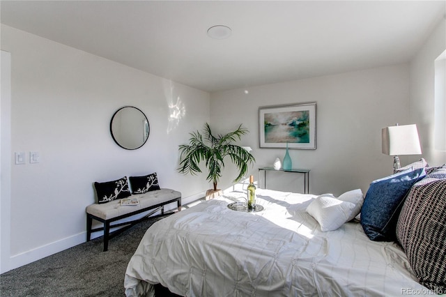 carpeted bedroom featuring baseboards