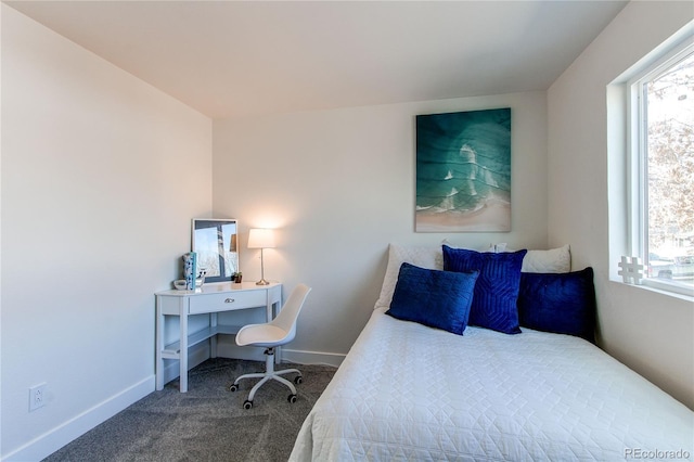 carpeted bedroom with multiple windows and baseboards