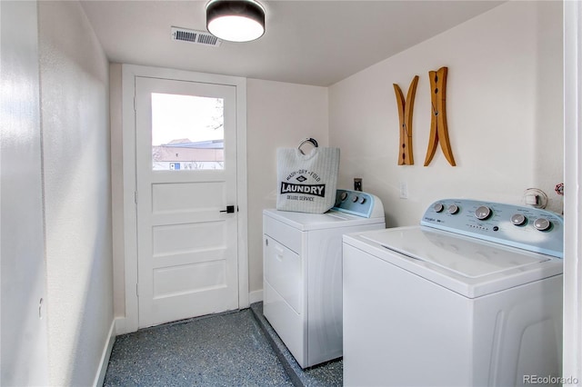 clothes washing area featuring laundry area, washing machine and dryer, visible vents, and baseboards