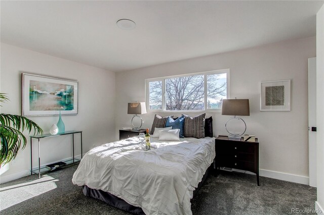 bedroom featuring carpet and baseboards