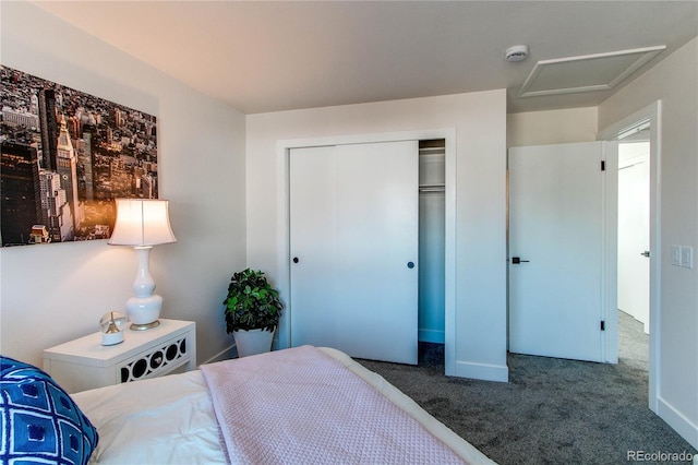 carpeted bedroom with a closet and attic access