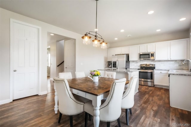 dining room featuring recessed lighting and dark wood-type flooring