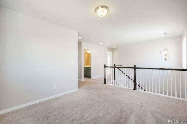 spare room featuring baseboards, recessed lighting, and light colored carpet
