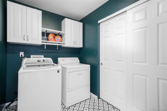 laundry area featuring cabinet space, baseboards, and washer and clothes dryer