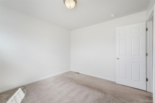 unfurnished room featuring baseboards and carpet flooring