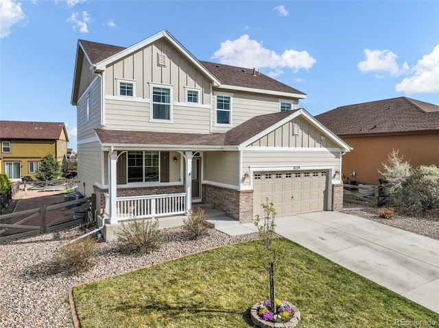 craftsman-style house featuring a garage, fence, covered porch, board and batten siding, and concrete driveway