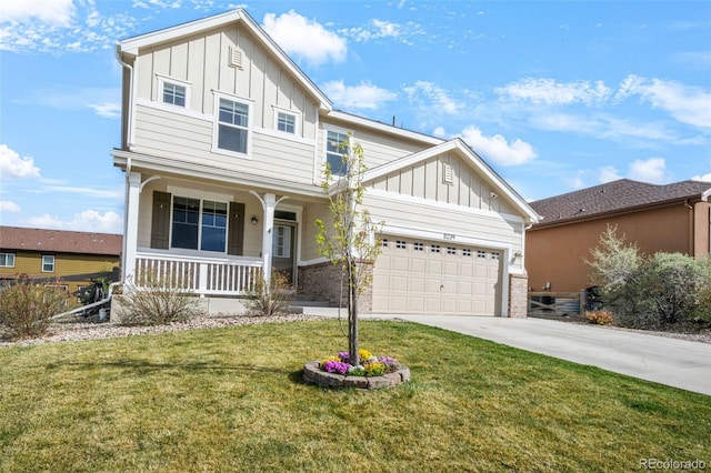 craftsman-style house with a front lawn, an attached garage, board and batten siding, a porch, and driveway