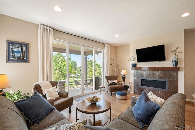 18067 E Anthem Dr, Parker, CO 80134 - living room featuring wood finished floors, recessed lighting, a fireplace, and baseboards