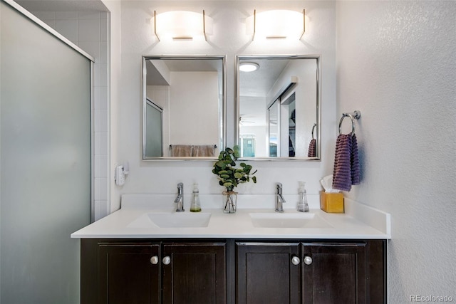 bathroom with vanity and a shower with shower door