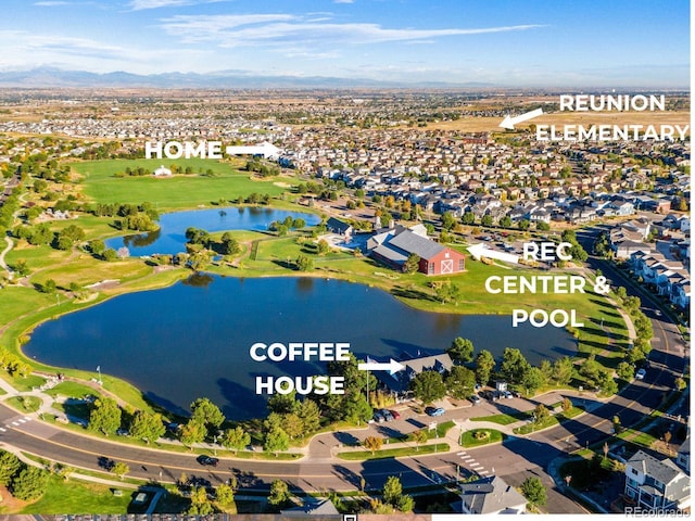 drone / aerial view with a water and mountain view