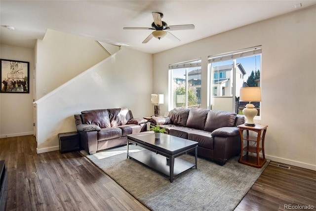 living room featuring ceiling fan and dark hardwood / wood-style floors