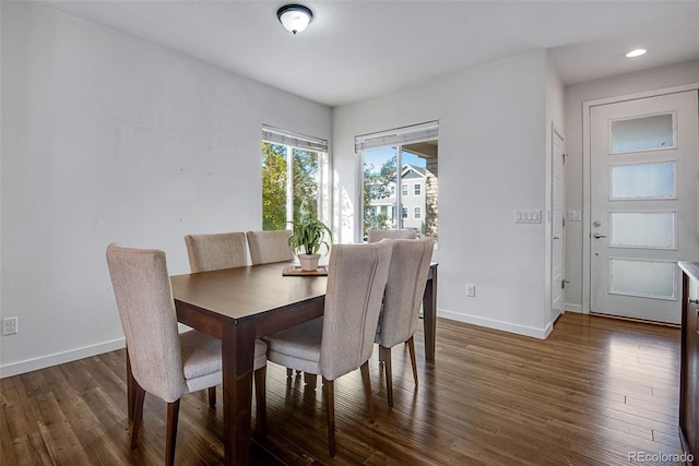 dining space with dark wood-type flooring