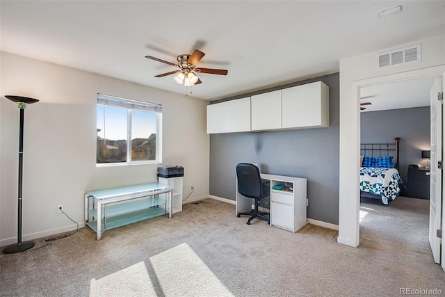 office space with light carpet and ceiling fan