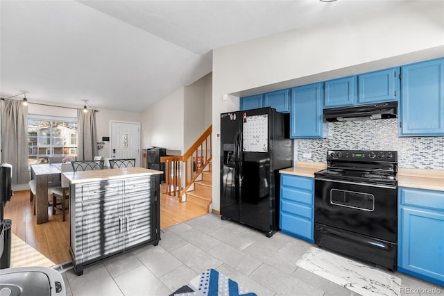 kitchen featuring blue cabinetry, decorative backsplash, black appliances, and lofted ceiling