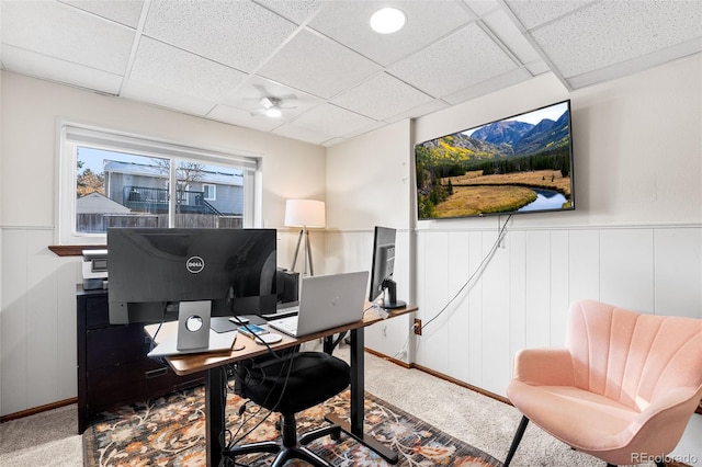 home office with a paneled ceiling, ceiling fan, and carpet floors