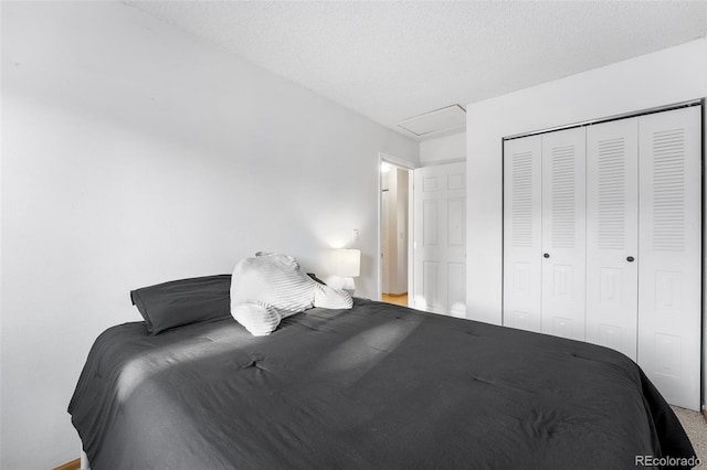 bedroom with a textured ceiling and a closet