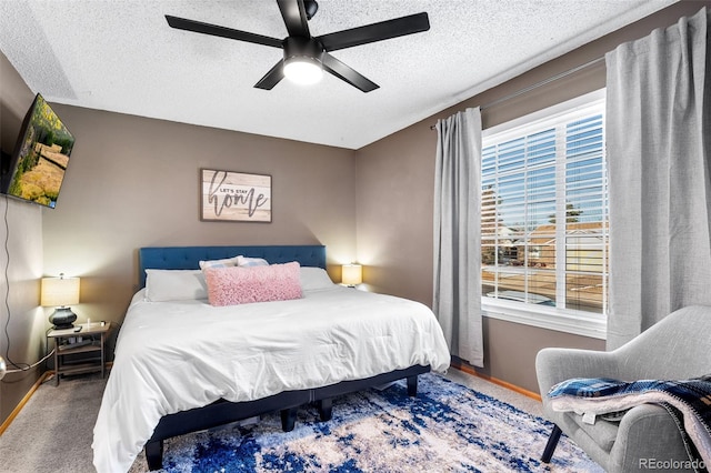 bedroom with carpet flooring, ceiling fan, and a textured ceiling