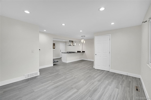 unfurnished living room with light wood-type flooring