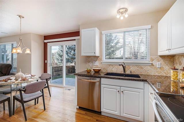 kitchen featuring sink, decorative light fixtures, stainless steel dishwasher, and white cabinets