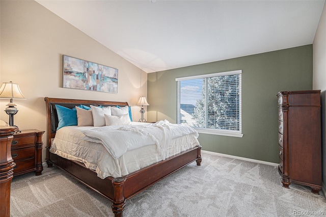 carpeted bedroom featuring lofted ceiling