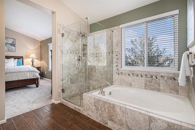 bathroom with vaulted ceiling, plus walk in shower, and plenty of natural light