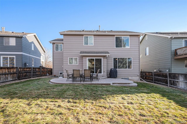 rear view of property featuring a yard and a patio