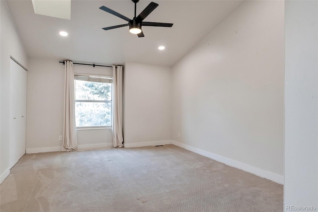 spare room with light carpet, ceiling fan, and lofted ceiling