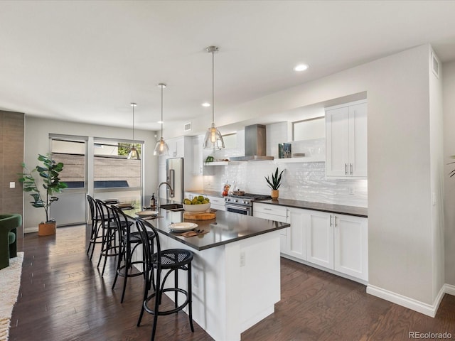 1819 Gaylord St, Denver, CO 80206 - kitchen with wall chimney range hood, premium appliances, dark countertops, dark wood-type flooring, and tasteful backsplash
