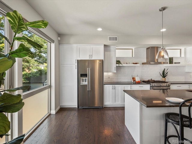 1819 Gaylord St, Denver, CO 80206 - kitchen featuring appliances with stainless steel finishes, wall chimney range hood, dark countertops, open shelves, and backsplash