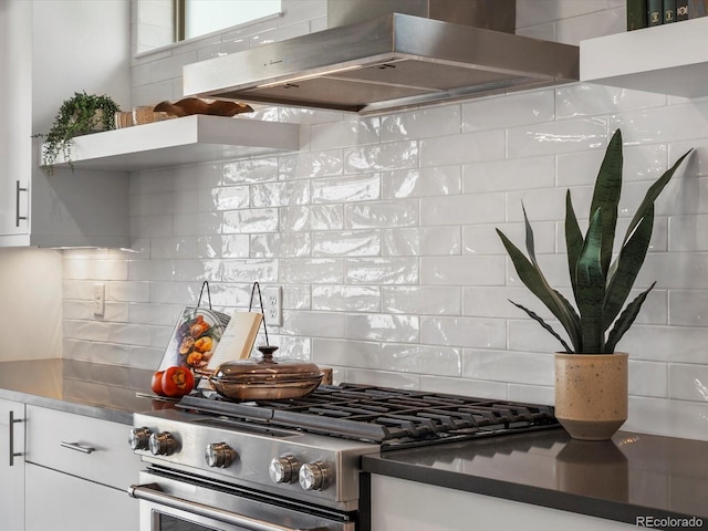 1819 Gaylord St, Denver, CO 80206 - kitchen featuring wall chimney exhaust hood, stainless steel gas range oven, backsplash, and white cabinets