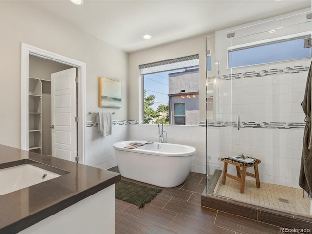 1819 Gaylord St, Denver, CO 80206 - full bathroom with a shower stall, vanity, a freestanding tub, tile walls, and recessed lighting