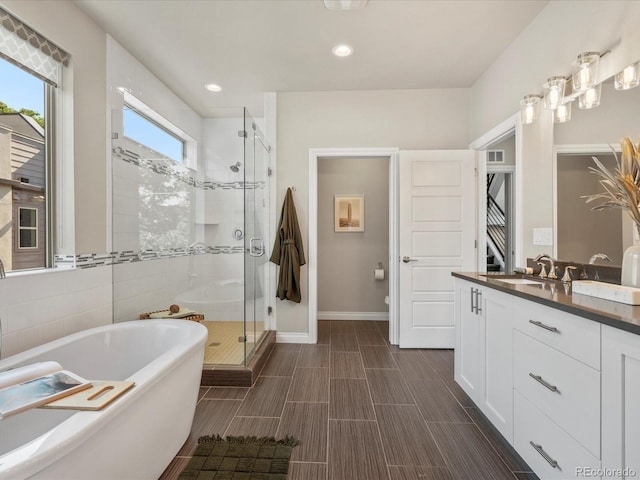1819 Gaylord St, Denver, CO 80206 - bathroom featuring a freestanding bath, a shower stall, vanity, and recessed lighting