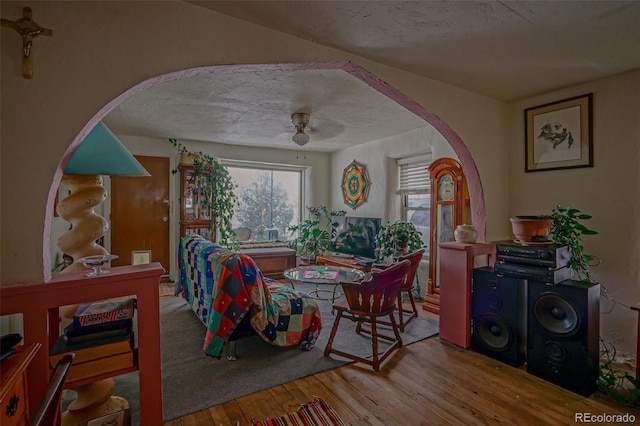 dining room with a textured ceiling, hardwood / wood-style floors, and ceiling fan