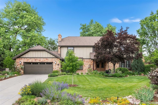 5185 W Fair Pl, Littleton, CO 80123 - view of front facade with a chimney, a garage, a front yard, and driveway