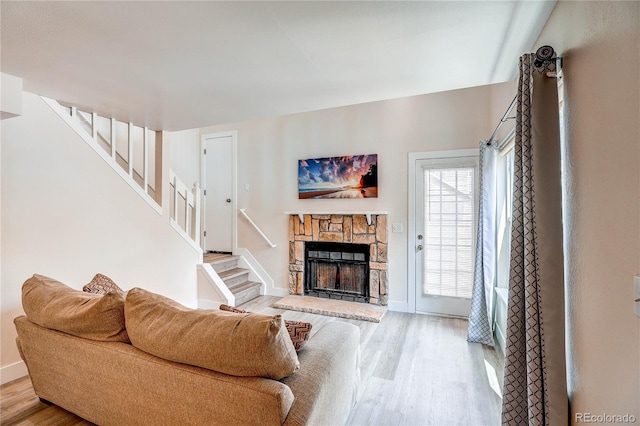 919 S Dawson Way Unit 14, Aurora, CO 80012 - living area with wood finished floors, stairway, and a stone fireplace