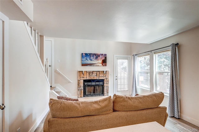 919 S Dawson Way Unit 14, Aurora, CO 80012 - living area featuring stairs, a stone fireplace, and light wood-type flooring