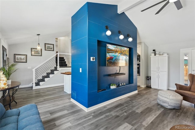 living room featuring vaulted ceiling with beams, hardwood / wood-style flooring, and ceiling fan