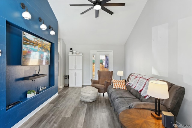 living room with ceiling fan, lofted ceiling, and wood-type flooring