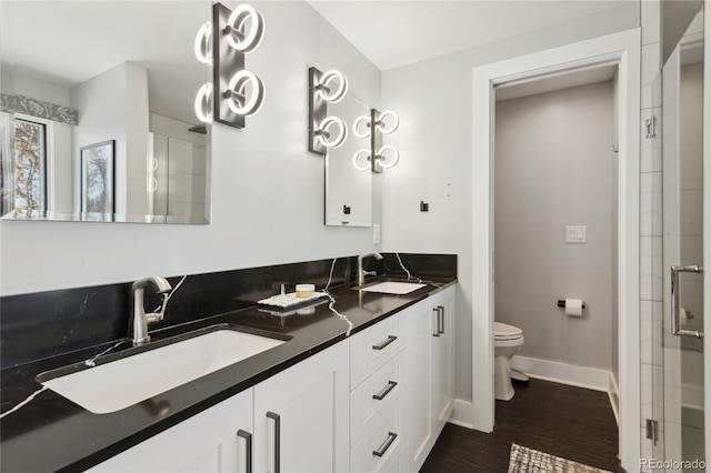 bathroom with vanity, wood-type flooring, toilet, and walk in shower