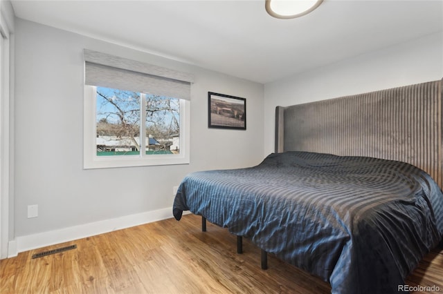 bedroom with hardwood / wood-style flooring