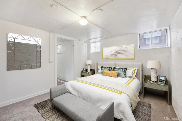 bedroom featuring light carpet and a textured ceiling