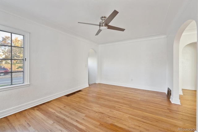 spare room with ceiling fan, ornamental molding, and light hardwood / wood-style floors