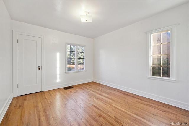 unfurnished room with light wood-type flooring